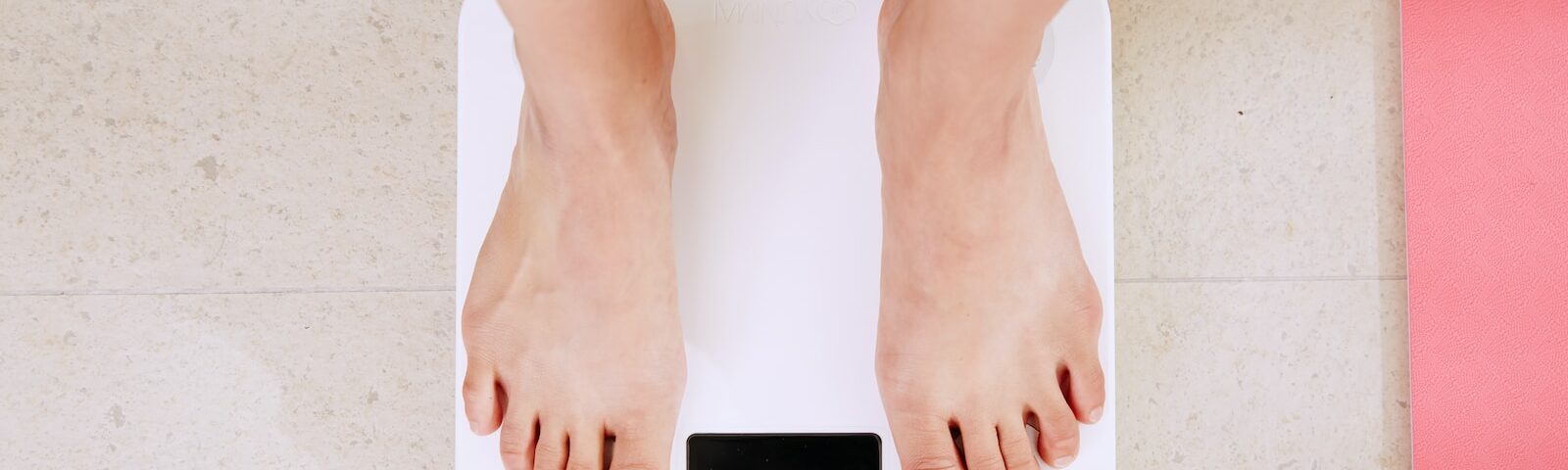 person standing on white digital bathroom scale